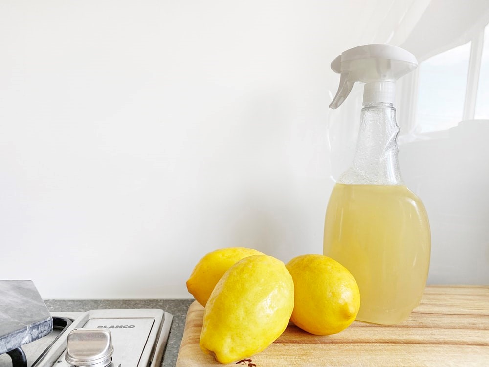 yellow lemon fruit beside clear glass bottle